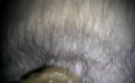 Hairy man pooping in close up