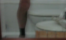 Stroking his cock while pooping on the floor