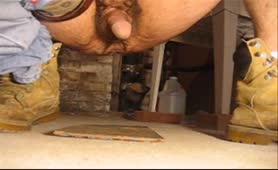 Mature man dropped a long brown turd on the garage floor