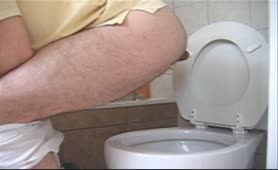 Constipated gay guy pooping big one over toilet