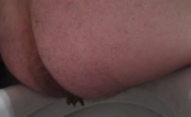 Hairy chubby guy pooping in toilet