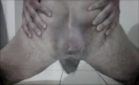 Teen boy spreading butt cheeks while pooping