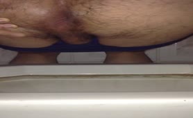 Hairy guy dropped a big turd in bathtub
