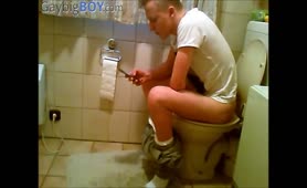 Young guy shitting in toilet