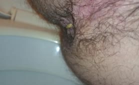 Holding his dick and balls while pooping
