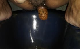 Indian guy shitting over toilet