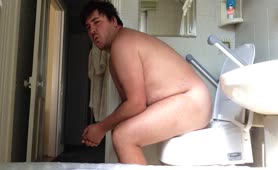 Nerd guy shitting in toilet