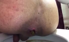 Mexican guy shitting in toilet