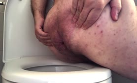 Hairy guy shitting in toilet