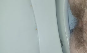 Hairy dude shitting in toilet